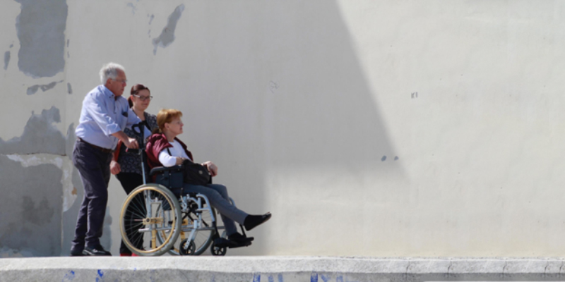 woman in wheelchair being pushed