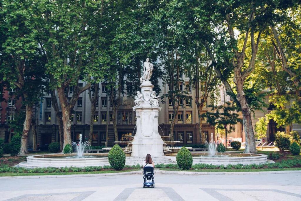 woman in a wheelchair near a fountain