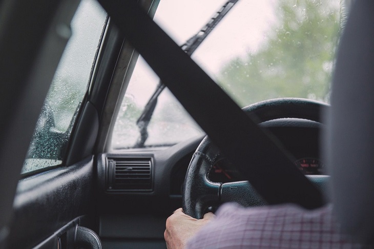 person driving car with seatbelt on