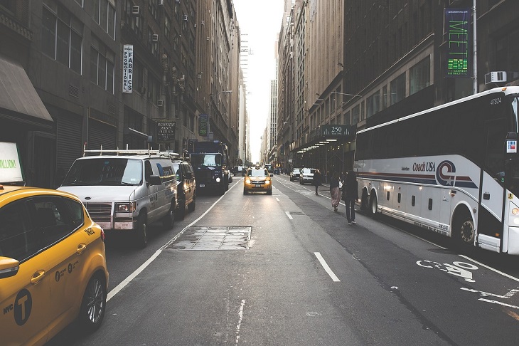 van and cars parked on street