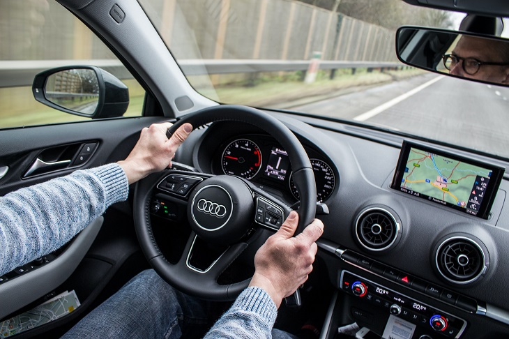 person behind the wheel of car